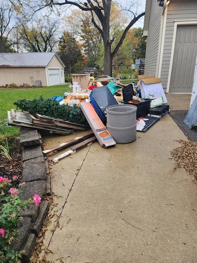 Dumpster being loaded with debris for 3 Yard Dumpster Rental in Kaukauna